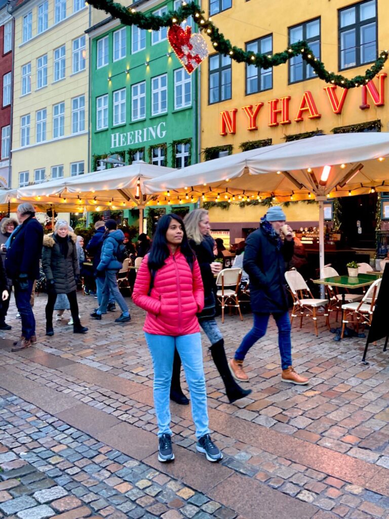 Agalya walking through the Nyhavn Christmas Market Copenhagen