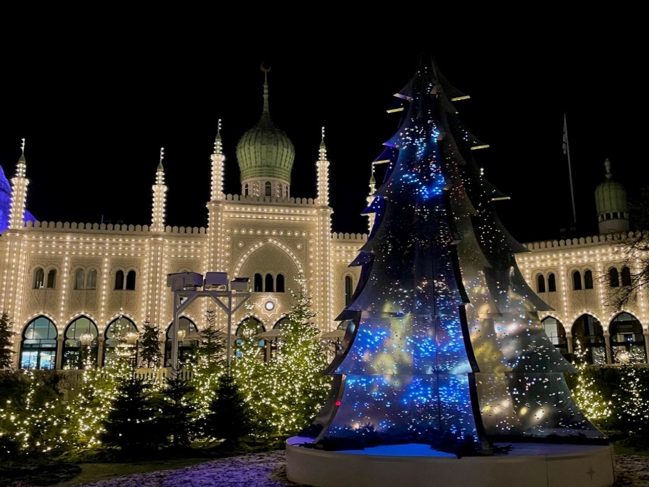 Christmas at Tivoli Gardens Copenhagen featuring Christmas tree and Nimb Hotel