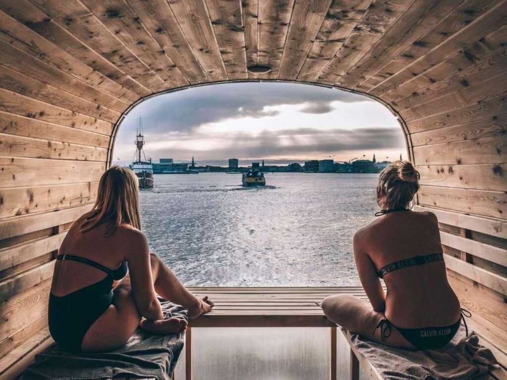 Two girls relaxing and starring the view at the Copenhot private sauna