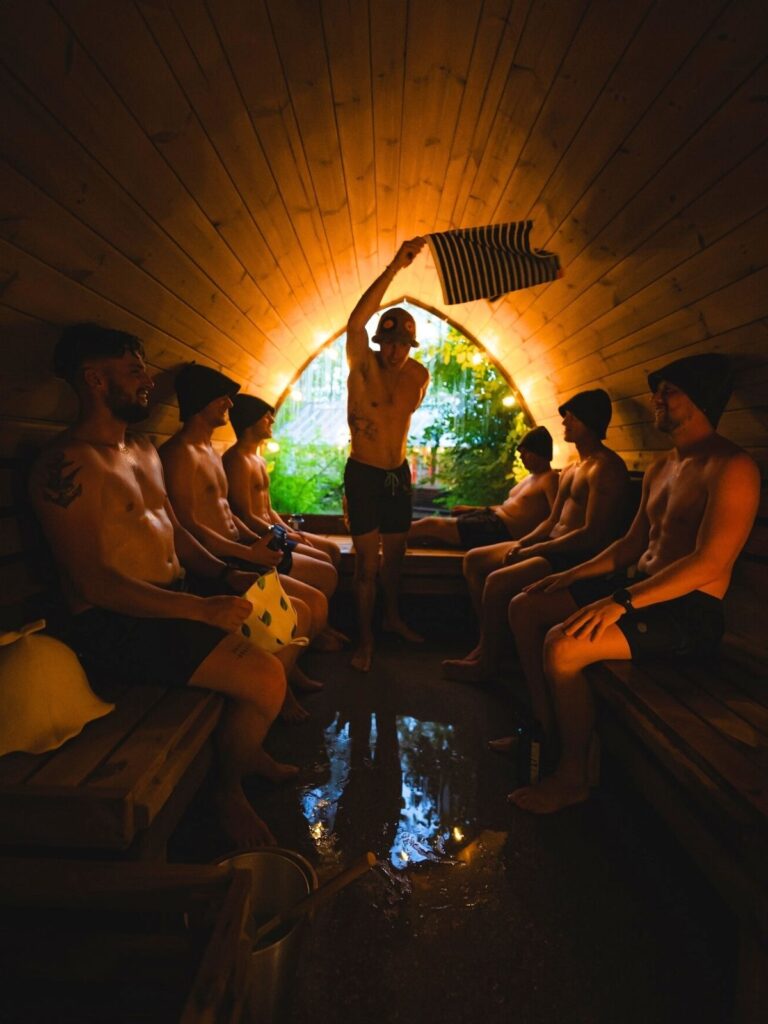 A Gusmaster swinging a towel during a saunagus session at Mobile Sauna Copenhagen