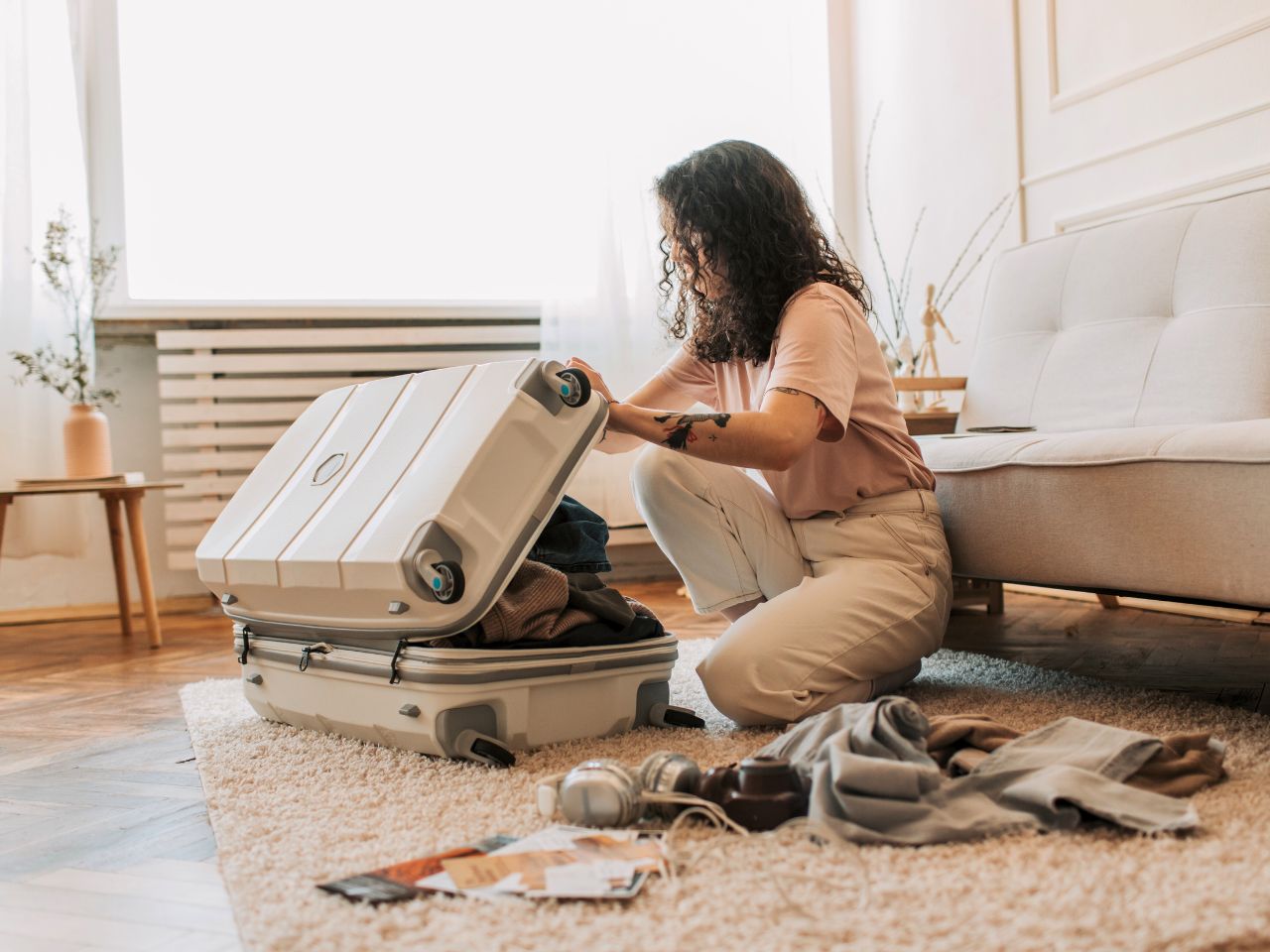 A girl packing her suitcase according to her packing list for Denmark