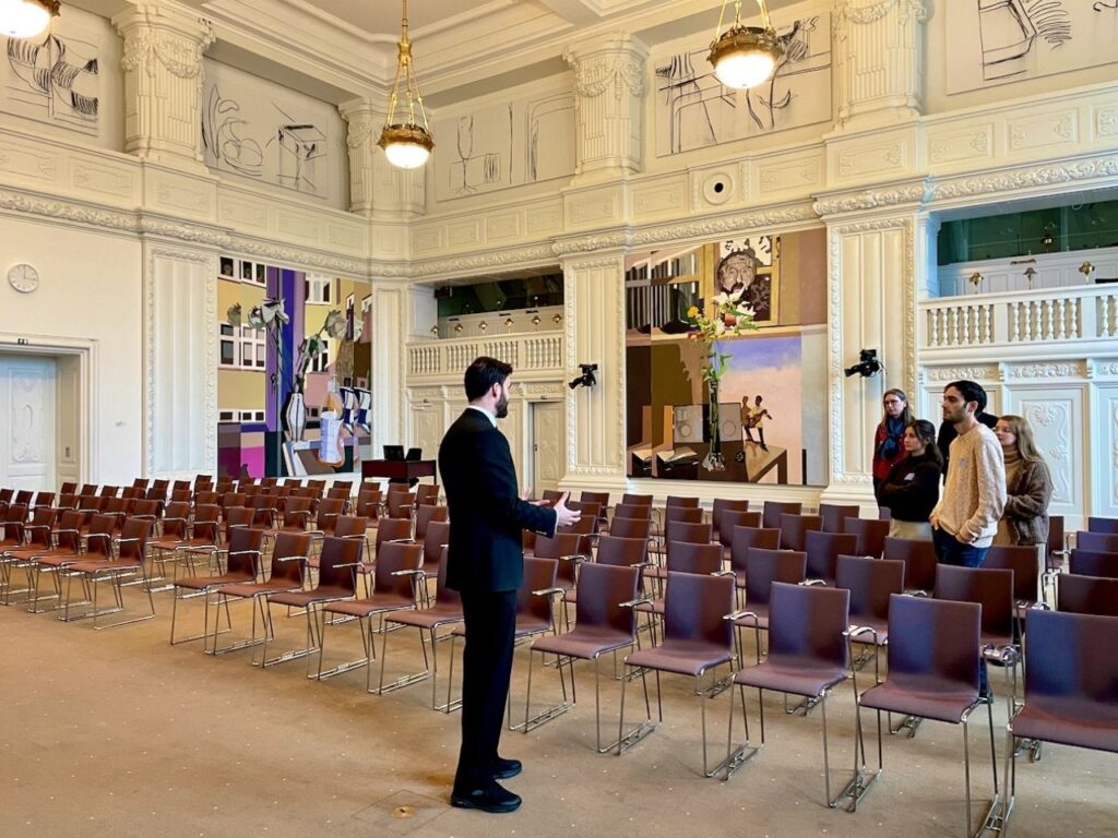 A guide explaining the Danish history to the visitors at the Christiansborg Palace, Copenhagen