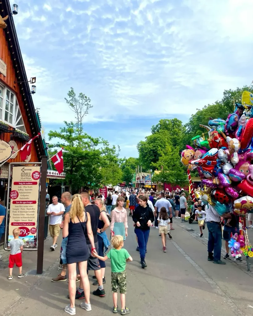 People with kids inside the Bakken amusement park Denmark