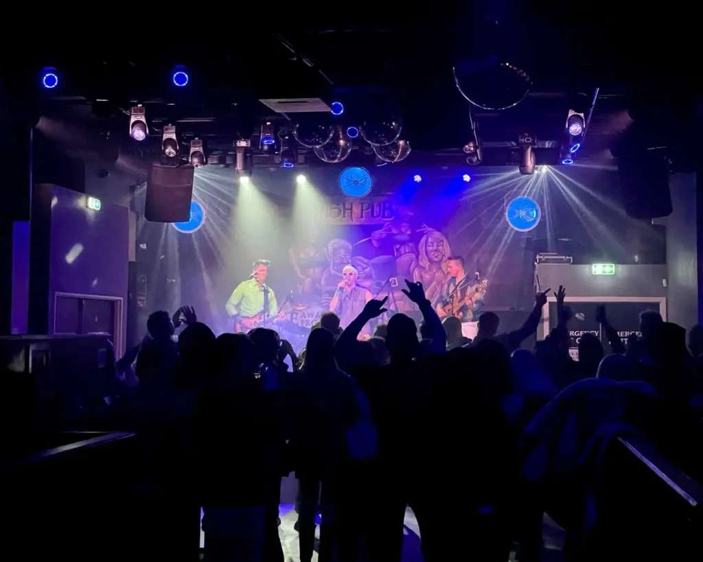 Irish pub singer performing live music and the crowd dancing