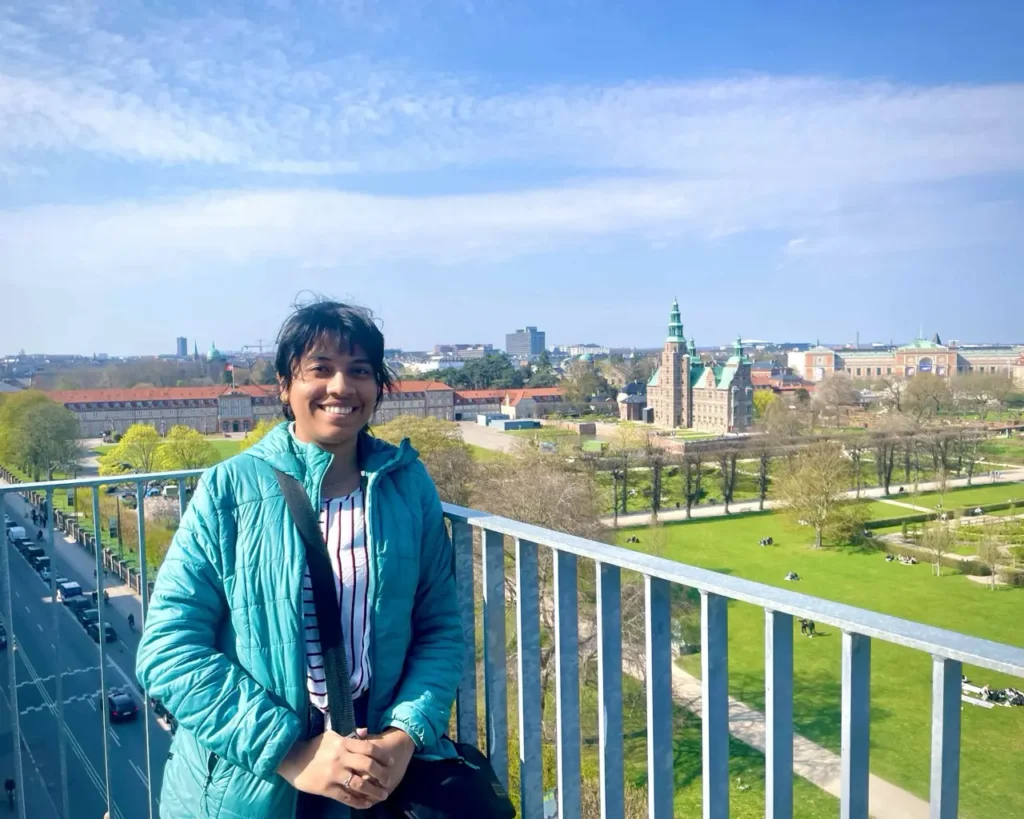 Agalya smiling happy after seeing the view of the city from Cinemateket rooftop